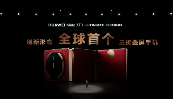 A person standing in front of a red and gold rectangular object

Description automatically generated